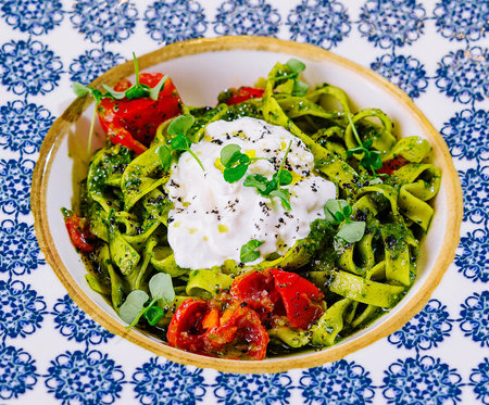 Plate of delicious pasta with pesto sauce close upの写真素材