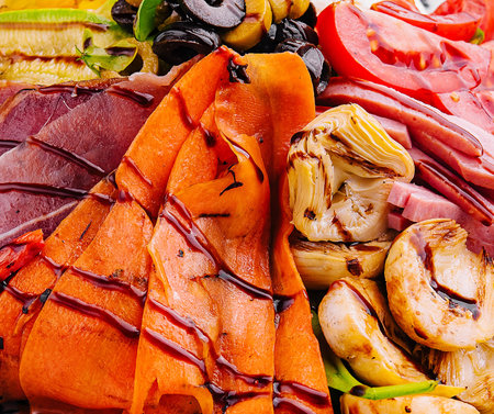 salad of various meats with mushrooms, carrots and lettuce leavesの写真素材