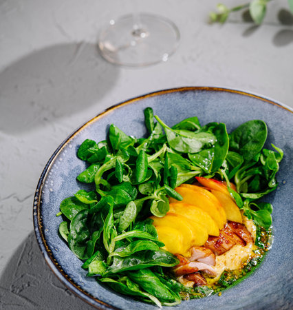 Appetizing pork meat baked with mango and cheeseの写真素材