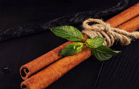 Mint with cinnamon on wood backgroundの写真素材