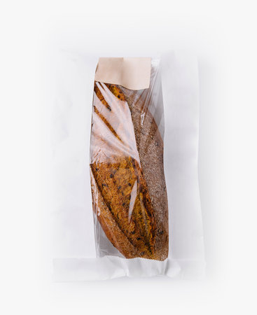 Top view of a fresh loaf of artisan bread in an open paper bag, isolated on a white backgroundの写真素材