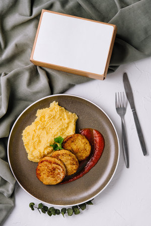 Plate with mashed potatoes and vegetable cutlets and sauce top viewの写真素材