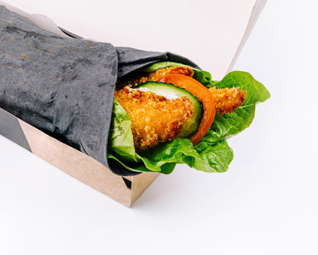 Healthy vegetable wrap in eco-friendly packaging, isolated on a white background for easy takeaway meal conceptsの写真素材