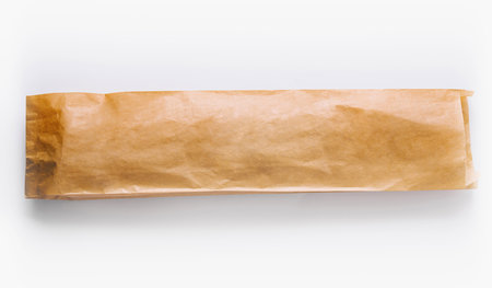 Blank upright brown paper bag ideal for packaging designs isolated on a white backdropの写真素材