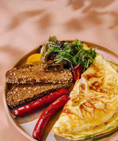 Delicious folded omelette with fresh greens, grilled peppers, and multigrain bread served on a...