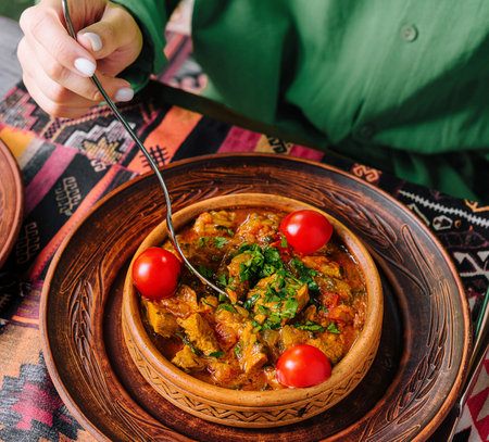 Patron savors a delicious stew in an ethnic restaurant settingの写真素材