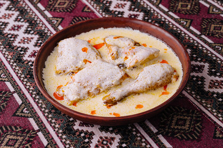 Delicious homemade chicken meal served in a rustic earthenware dishの写真素材