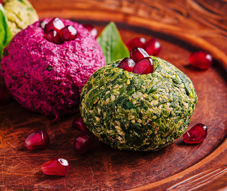 two of green and pink on rustic plate adorned with pomegranateの写真素材