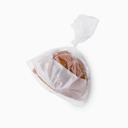 Sealed loaf of whole grain bread in plastic bag isolated on whiteの写真素材