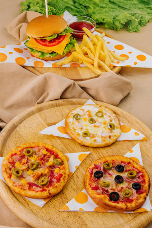 Appetizing display of burgers, pizzas, and fries, ready for a tasty mealの写真素材