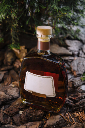 High-quality image showcasing a crafted bottle of cognac amid natural wooden texturesの写真素材