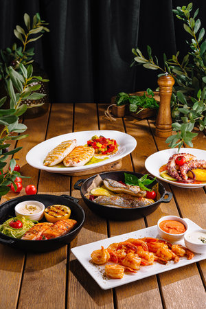 Array of delicious mediterranean dishes displayed on a wooden table, perfect for food enthusiastsの写真素材