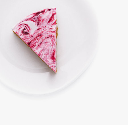 Single slice of raspberry swirl cheesecake presented on a pristine white dish, isolated on white backgroundの写真素材