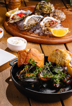 Sumptuous array of mediterranean dishes artistically presented on a warm wooden backdropの写真素材