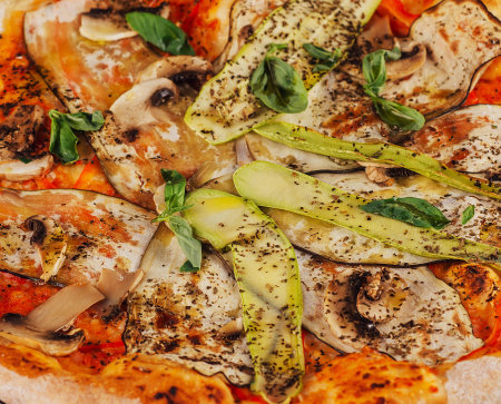 Closeup photo of gourmet vegetarian pizza with fresh ingredients for food photography and italian cuisine. Enjoy this plant-based dinner or lunch option, whether homemade or from a pizzeriaの写真素材