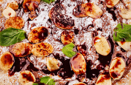 Grilled banana slices with melted chocolate and mint leavesの写真素材