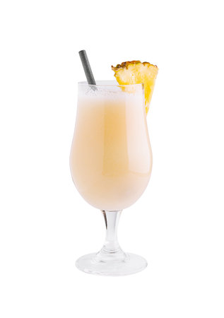 Refreshing pina colada cocktail is standing on a white background with a black straw and a pineapple...