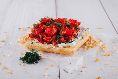 Delicious sandwich with red peppers, fresh dill and cream cheese lying on white wooden tableの写真素材
