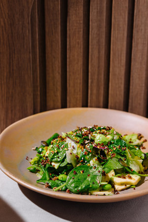 Fresh vegetarian lunch bowl with quinoa and avocado on wooden backgroundの写真素材