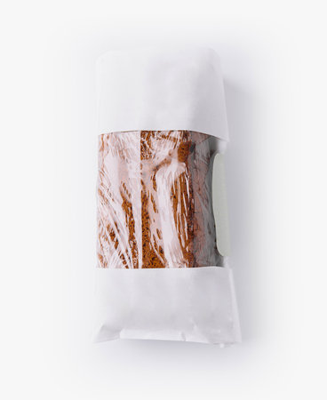 Delicious loaf of banana bread is being presented in a paper bag with a transparent windowの写真素材