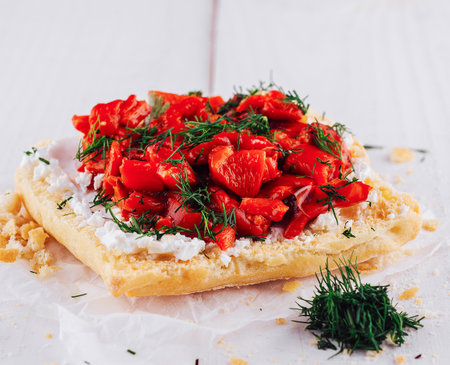 Delicious sandwich with red peppers, fresh dill and cream cheese lying on white wooden tableの写真素材