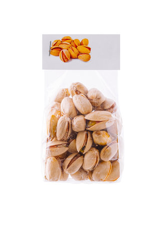 Transparent plastic bag filled with pistachios standing up is isolated on a white backgroundの写真素材