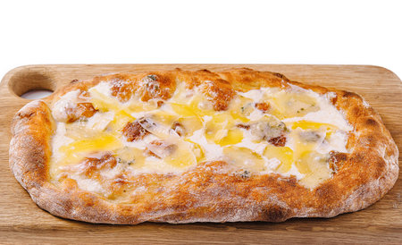 Delicious four cheese pizza with a crispy crust lying on a wooden boardの写真素材