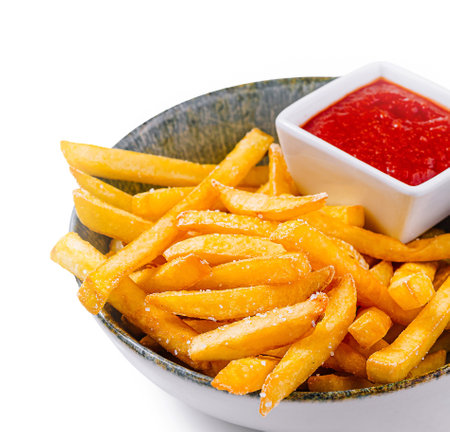 Delicious and crispy french fries with ketchup in a bowl, perfect for a tasty snack or side dishの写真素材