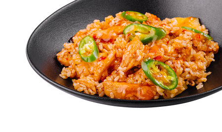 Spicy chicken and rice dish with jalapenos being served on a black plateの写真素材