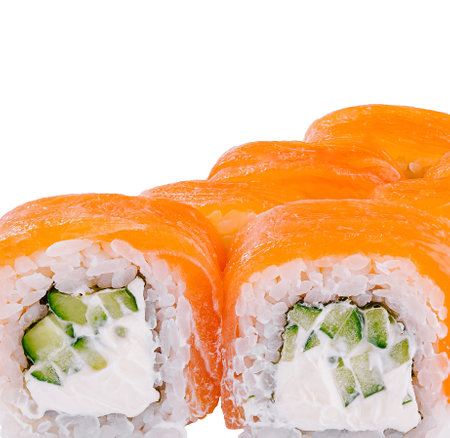 Sushi rolls with salmon, cream cheese and cucumber standing on white backgroundの写真素材