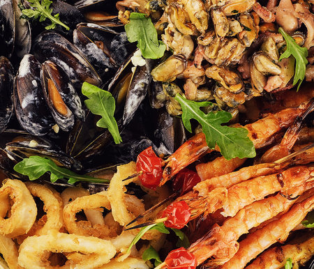 Delicious gourmet seafood platter delight featuring prawns. Mussels. And calamari. A variety of shellfish. And fresh shrimps and squidの写真素材