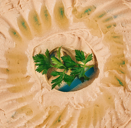 Delicious hummus with parsley and olive oil beingの写真素材