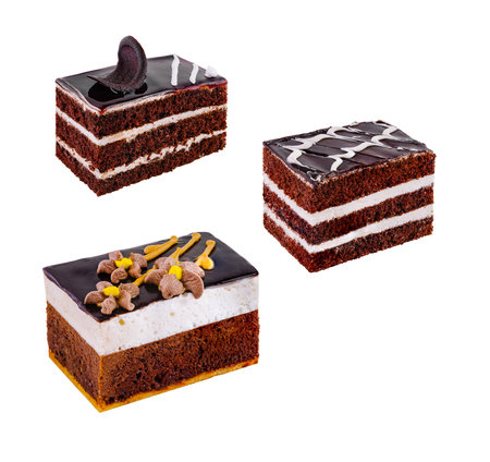 Three slices of delicious chocolate cake with various toppings and layers, isolated on a white backgroundの写真素材
