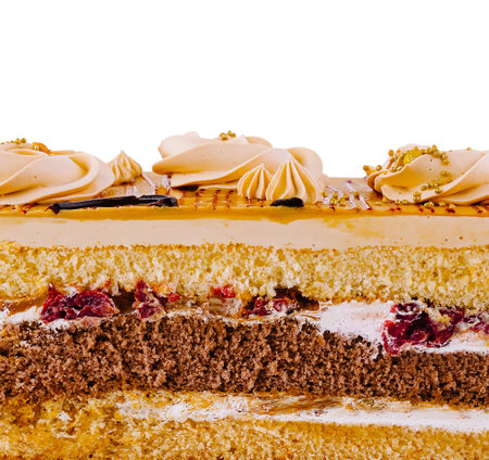 Delicious cake is showing its multiple layers of cake, cream and fruit fillingの写真素材