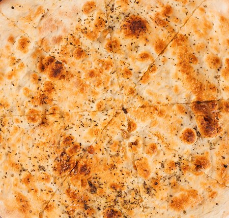 Freshly baked focaccia bread seasoned with herbs and spices, making a perfect appetizer or side dishの写真素材