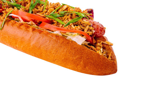 Scrumptious hot dog loaded with assorted condiments, isolated on a white backgroundの写真素材