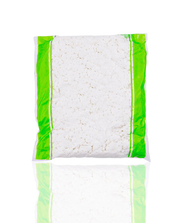 Sealed plastic bag of cottage cheese is standing up with a slight reflection on a white backgroundの写真素材