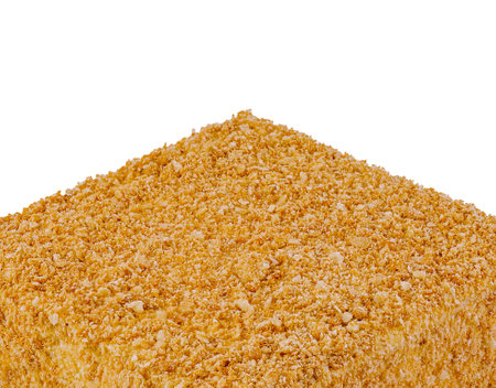 Square honey cake covered with crumbs standing on white backgroundの写真素材