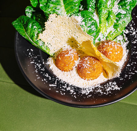 Delicious classic caesar salad topped with shredded parmesan, served on a stylish plate