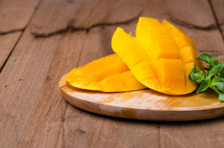 mango slice on wood background