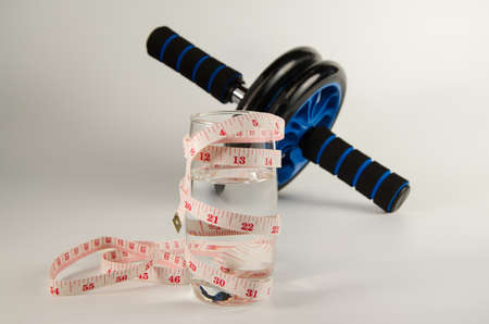glass water with measure tape on isolated background and healthyの写真素材