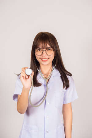 young female doctor standing on isolated backgroundの写真素材