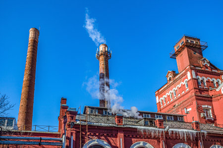 Industrial buildings and chimneys of an old red brick factory in Moscow, Russiaの写真素材