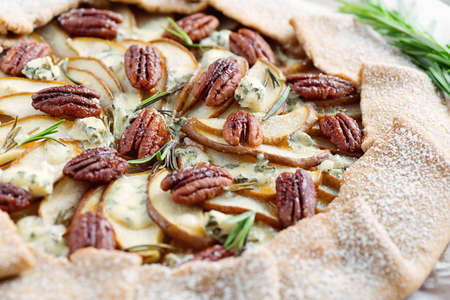 Spicy Galette pie made from whole rye flour with pears, pecan nuts, blue cheese and rosemaryの写真素材