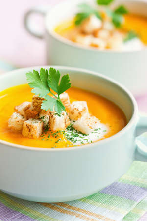 Pumpkin soup puree with croutons and parsleyの写真素材
