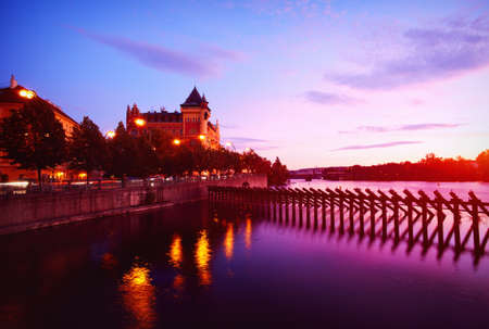 Embankment of the Vltava river near the Charles Bridge in the center of Prague in duskの写真素材