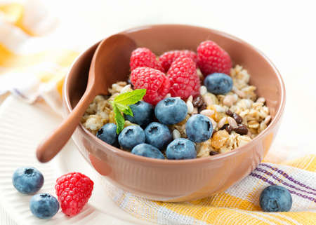 Healthy vegetarian breakfast with oatmeal, raisin and berriesの写真素材