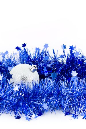 christmas colored balls in an environment of  a tinsel on a white background vertical frameの写真素材