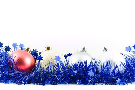 christmas colored balls in an environment of  a tinsel on a white backgroundの写真素材