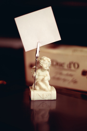 elegant stick holder in the form of angel on a tableの写真素材